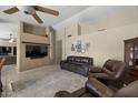 Comfortable living room with plush leather seating, a large TV, and cozy, neutral decor at 843 E Vera Ln, Tempe, AZ 85284