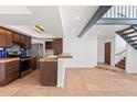 Modern kitchen and dining area featuring stainless steel appliances, wooden cabinets, and tiled countertops at 8844 S 51St St # 3, Phoenix, AZ 85044