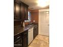 Updated kitchen featuring granite countertops, dark cabinetry, and modern appliances at 913 E Beryl Ave, Phoenix, AZ 85020