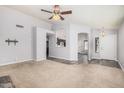 Spacious living room with plush carpet, multiple doorways, and ample natural light at 924 E Baylor Ln, Gilbert, AZ 85296