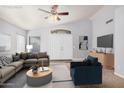 A staged living room with vaulted ceilings, a comfortable sofa, a chair, and lots of natural light at 924 E Baylor Ln, Gilbert, AZ 85296