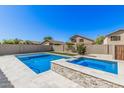 Relaxing backyard featuring a pristine pool, spa, and a well-maintained yard, perfect for outdoor living at 924 E Baylor Ln, Gilbert, AZ 85296