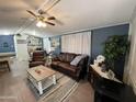 Inviting living room features cozy furniture, a ceiling fan and neutral flooring at 9302 E Broadway Rd # 49, Mesa, AZ 85208