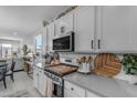 Modern kitchen with white cabinetry, stainless steel appliances, and countertops with stylish accessories at 11357 E Unger Ave, Mesa, AZ 85212