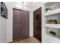 Hallway with built in shelving, light walls, and a closet with brown sliding doors at 14216 N Saguaro Blvd # A, Fountain Hills, AZ 85268