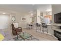 Cozy living room with a fireplace, breakfast bar, and comfortable seating at 14950 W Mountain View Blvd # 1112, Surprise, AZ 85374