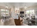 Open floor plan with living room, kitchen, dining, and patio access at 14950 W Mountain View Blvd # 1112, Surprise, AZ 85374