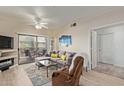 A cozy living room with a comfortable seating and access to the outdoor patio at 14950 W Mountain View Blvd # 1112, Surprise, AZ 85374