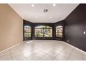 Bright living room boasts elegant tile floors, large windows offering neighborhood views, and two-tone walls at 1590 W Desert Broom Dr, Chandler, AZ 85248