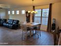 Open concept dining area with tile flooring, chandelier, and large windows for plenty of natural light at 15951 W Yavapai St, Goodyear, AZ 85338