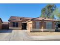 Charming single-story home with a tile roof, tidy landscaping, and a welcoming front entrance at 15951 W Yavapai St, Goodyear, AZ 85338