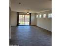 Bright living room featuring tiled floors, recessed lighting, and sliding glass doors at 15951 W Yavapai St, Goodyear, AZ 85338