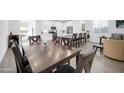 Elegant dining room with a large wooden table and seating for eight at 16593 W Alameda Rd, Surprise, AZ 85387