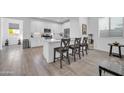 Modern kitchen featuring white cabinets, stainless steel appliances, and a center island at 16593 W Alameda Rd, Surprise, AZ 85387