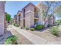 Beautiful condo building with stucco walls, covered balconies, and desert landscaping at 17017 N 12Th St # 2117, Phoenix, AZ 85022