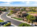 Beautiful aerial view showcasing the home's well-manicured lawn, palm trees, and neighborhood at 18330 W Woodrow Ln, Surprise, AZ 85388