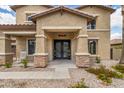 Charming home featuring a covered entrance, stone accents, and an inviting front porch at 18330 W Woodrow Ln, Surprise, AZ 85388