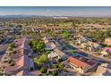 Scenic aerial view of the neighborhood with lush green golf course and mountain backdrop at 19472 N Marble Canyon Ct, Surprise, AZ 85374