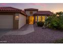Charming single-story home boasts a well-maintained desert landscape and inviting front entrance at 19472 N Marble Canyon Ct, Surprise, AZ 85374