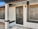 Close up of secured front door and porch with brick detail and security door at 19604 N 13Th Ave, Phoenix, AZ 85027