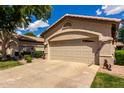Charming single-Gathering home featuring a beige exterior, desert landscaping and a two-car garage at 23813 S Pleasant Way, Sun Lakes, AZ 85248