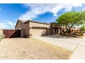 Exterior view of single story home with three car garage, desert landscaping, and shade trees at 25845 N 44Th Ave, Phoenix, AZ 85083