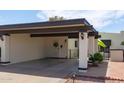 Attached covered carport with decorative dark beams and exterior sconces at 2938 S Country Club Way, Tempe, AZ 85282