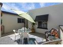 Private patio with outdoor dining table and chairs, adjacent to the front door at 2938 S Country Club Way, Tempe, AZ 85282