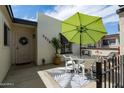 Private patio space with an umbrella-covered dining table and chairs, perfect for outdoor living at 2938 S Country Club Way, Tempe, AZ 85282