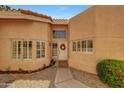 Charming home entrance with a decorative wreath on the front door and beautifully landscaped front yard at 3234 E Briarwood Ter, Phoenix, AZ 85048