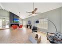 Spacious living room with tile flooring, vaulted ceilings, fireplace, and large windows at 3234 E Briarwood Ter, Phoenix, AZ 85048