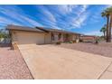 Single-story home featuring a two-car garage with a concrete driveway and desert landscaping at 4106 W Mission Ln, Phoenix, AZ 85051