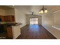 Spacious living room with a ceiling fan, access to the backyard, and a view of the open kitchen at 419 W Harwell Rd, Phoenix, AZ 85041