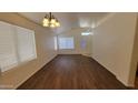 Bright living room featuring wood floors, neutral walls, and large windows with ample natural light at 419 W Harwell Rd, Phoenix, AZ 85041