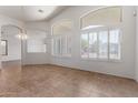 Open-concept living room featuring tile floors and plenty of natural light through shuttered windows at 4617 W Alicia Dr, Laveen, AZ 85339