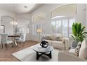 Bright living room featuring neutral tones, large windows, and modern furnishings for a comfortable and stylish space at 4617 W Alicia Dr, Laveen, AZ 85339