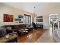 Bright living room featuring hardwood floors, high ceilings, and ample natural light from large windows at 4812 E Daley Ln, Phoenix, AZ 85054
