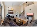 Spacious living room showcasing a comfortable sectional sofa, high ceilings, and staircase at 4812 E Daley Ln, Phoenix, AZ 85054