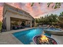 Gorgeous backyard oasis with a large pool, spa, covered patio, and a cozy fire pit at 4812 E Daley Ln, Phoenix, AZ 85054