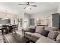 Open-concept living room with dining area, a comfortable sofa and neutral tones creating an inviting atmosphere at 5015 E Cheyenne Dr # 31, Phoenix, AZ 85044
