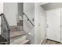 Staircase featuring modern wooden steps with metal railing, providing access to different levels of the home at 5015 E Cheyenne Dr # 31, Phoenix, AZ 85044
