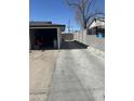 Wide concrete driveway leading to a garage, showcasing ample parking and backyard access at 520 W Mcneil St, Phoenix, AZ 85041