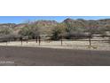 Scenic view of mountains behind a gravel trail and a metal rail, promoting outdoor activities at 520 W Mcneil St, Phoenix, AZ 85041