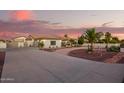 Beautiful home with a long driveway, lush desert landscaping, and an attached garage at 5511 N 128Th Dr, Litchfield Park, AZ 85340