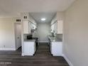 Bright kitchen with granite counters, stainless steel appliances, white cabinets, and wood-look floors at 555 N May -- # 29, Mesa, AZ 85201