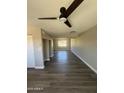 Inviting living area with wood flooring, fan, and a view to the front of the property at 5723 N 44Th Ln, Glendale, AZ 85301