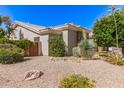 A single-story house featuring desert landscaping, offering a unique and water-efficient design at 621 W Desert Ave, Gilbert, AZ 85233