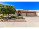 Inviting single-story home with a well-maintained lawn, mature tree, and a two-car garage at 621 W Desert Ave, Gilbert, AZ 85233