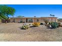 Charming single-story home featuring desert landscaping, cozy curb appeal, and ample natural light at 6602 E Heather Dr, Mesa, AZ 85215