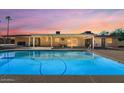 Inviting backyard oasis featuring a sparkling pool, covered patio, and outdoor living space for relaxation and entertainment at 6602 E Heather Dr, Mesa, AZ 85215